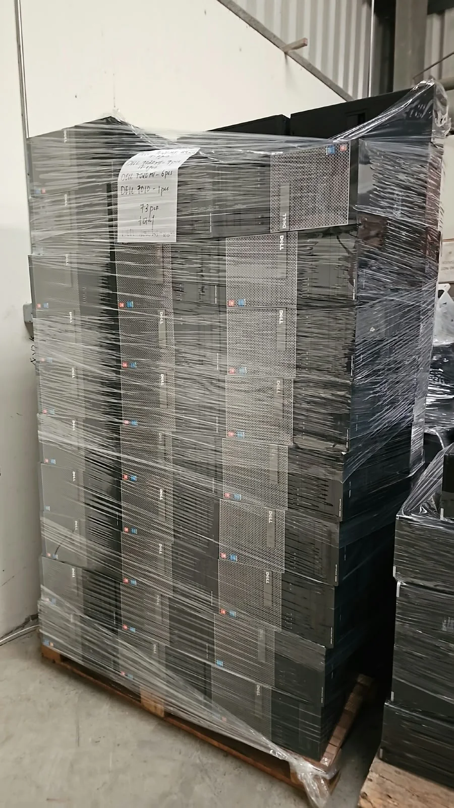 Shrink-wrapped pallet of used Dell OptiPlex tower desktops