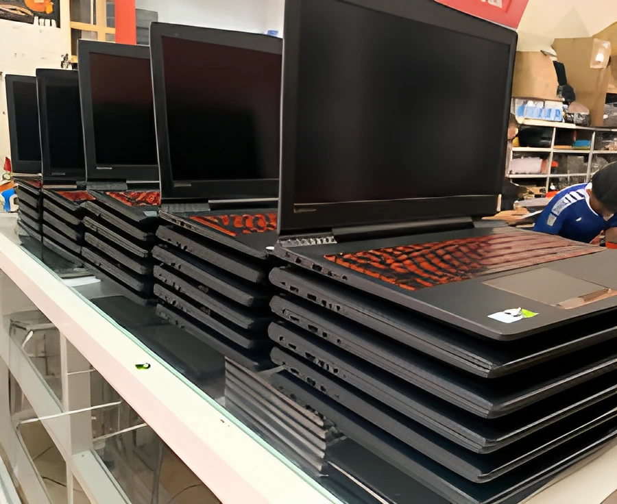 Gaming laptops with backlit keyboards lined up for testing